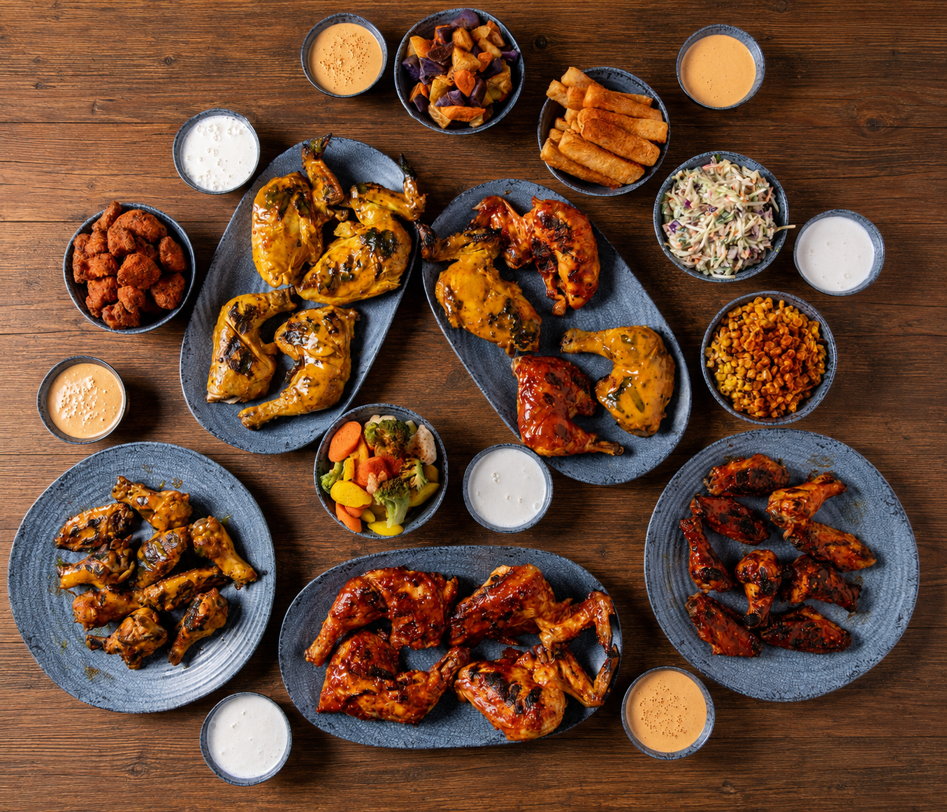 Peri Peri Bistro hero spread of grilled chicken, sides, and sauces